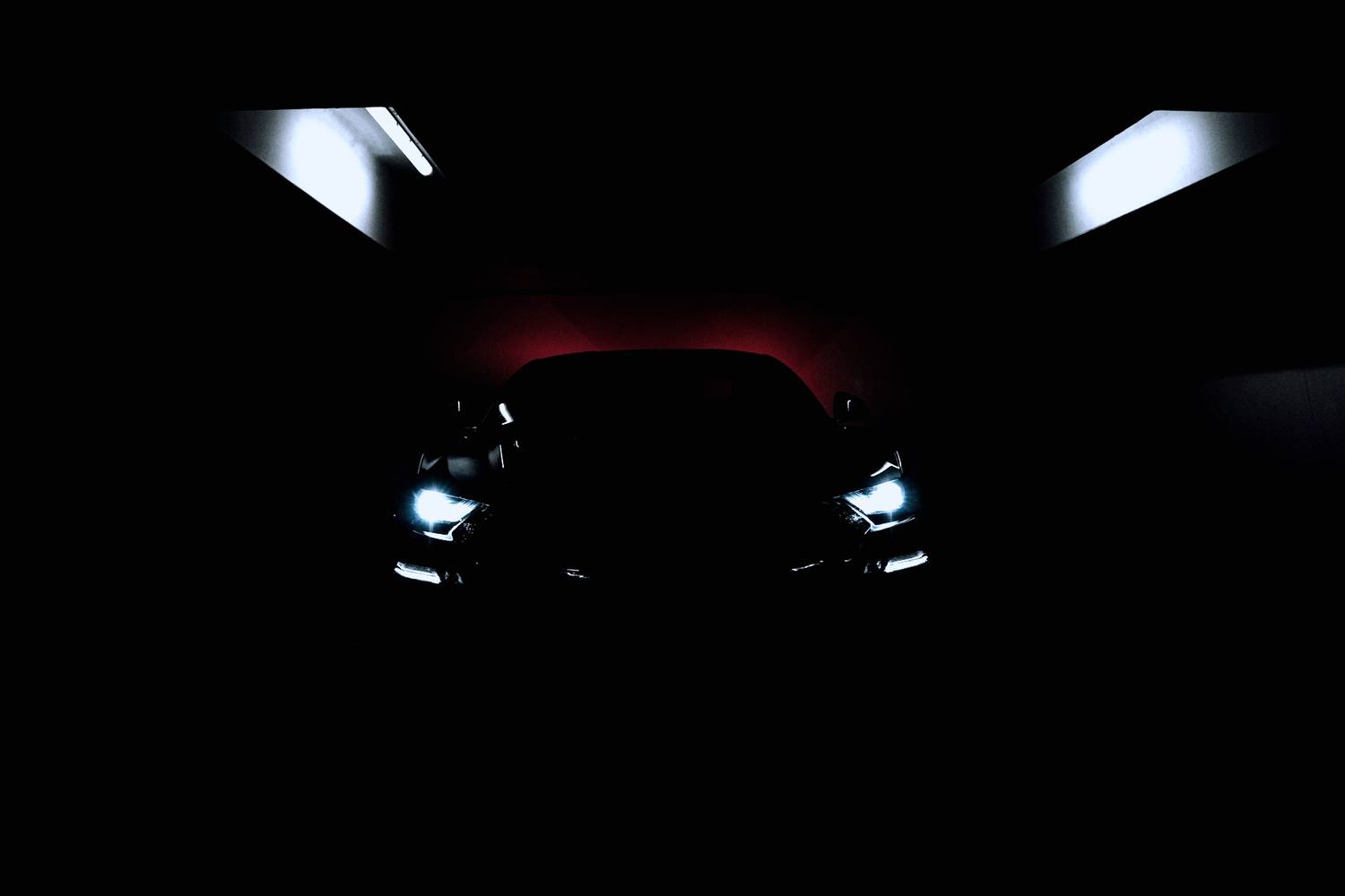 Dark car under low workshop light