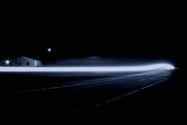 Light trail across a dark road