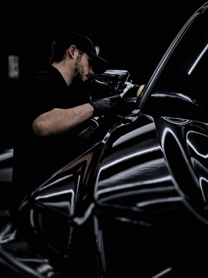 Installer cleaning vehicle glass before application
