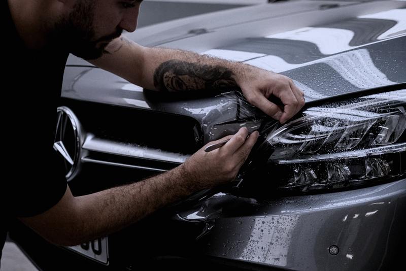 Film being laid over a vehicle panel