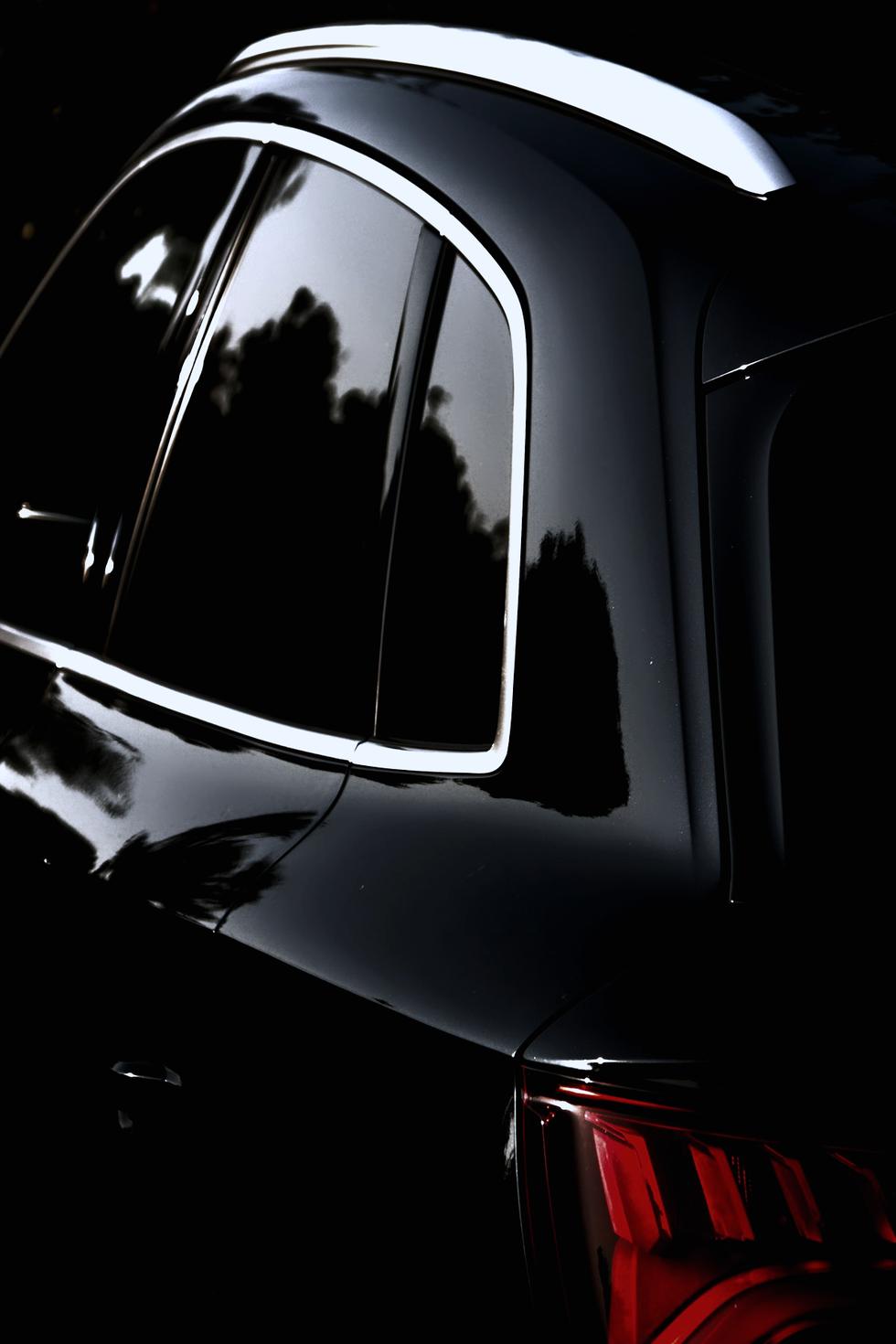 Rear glass of a dark vehicle with film applied