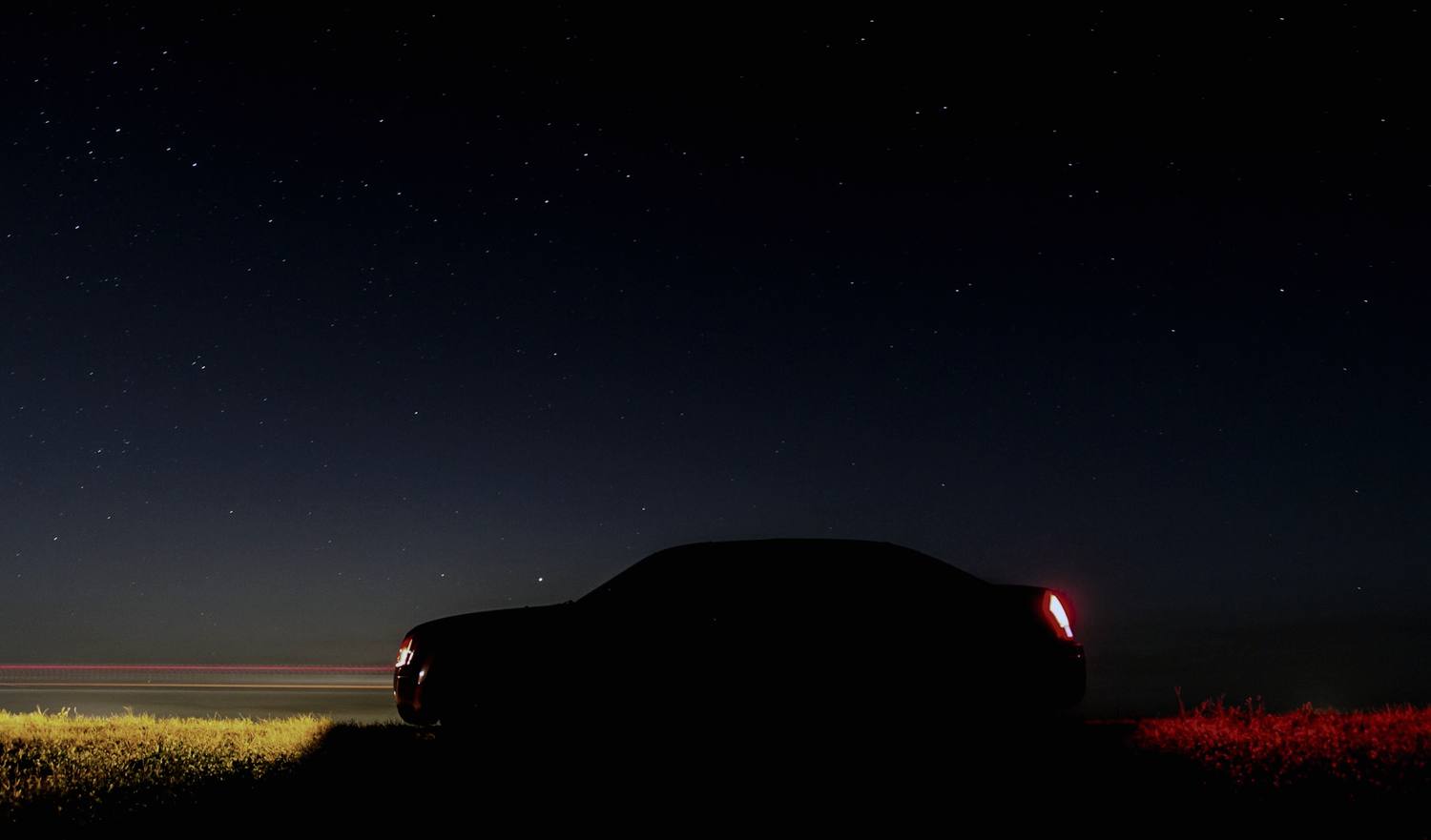 Silhouette of a car against a night sky